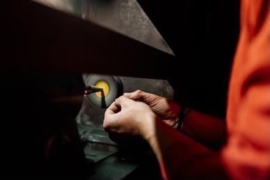 Hand-polishing a sterling silver piece at the jeweler's workbench